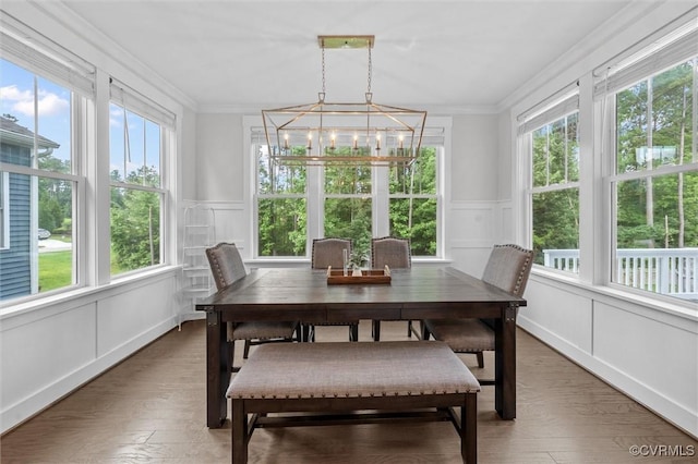 18007 Twin Falls Ln, Moseley, VA 23120 - dining room with a decorative wall, ornamental molding, a chandelier, wainscoting, and light wood finished floors
