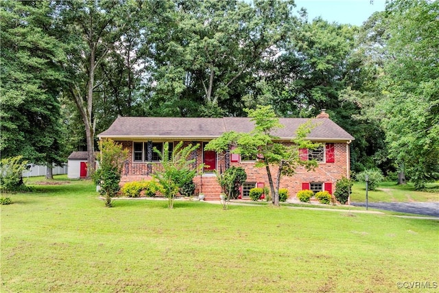 1020 Challis Ln, Sandston, VA 23150 - view of front of home with a front lawn, brick siding, a storage shed, and a chimney