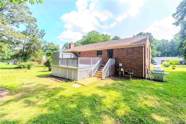 1020 Challis Ln, Sandston, VA 23150 - back of house featuring brick siding, a lawn, a deck, and a chimney
