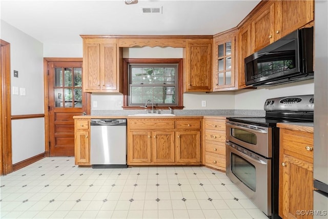 1020 Challis Ln, Sandston, VA 23150 - kitchen featuring appliances with stainless steel finishes, light flooring, healthy amount of natural light, and light countertops