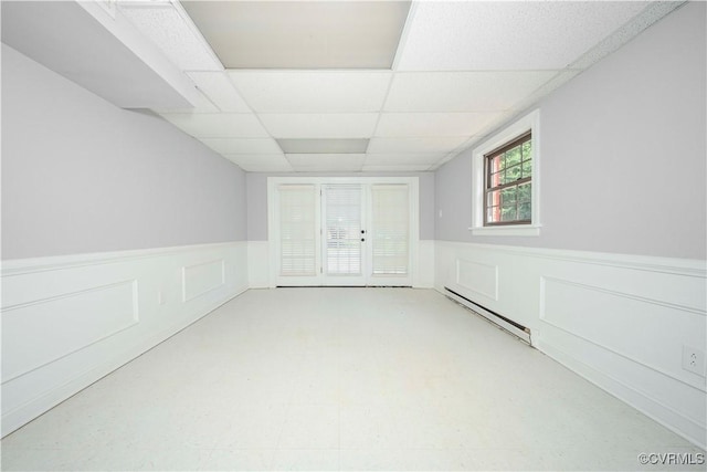 1020 Challis Ln, Sandston, VA 23150 - spare room featuring wainscoting, a baseboard heating unit, a paneled ceiling, and a decorative wall