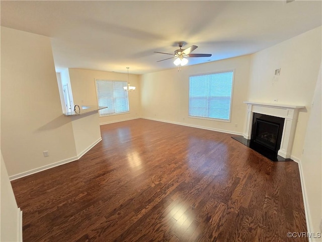16813 Laurel Park Dr, Moseley, VA 23120 - unfurnished living room with a fireplace with raised hearth, a chandelier, dark wood-style flooring, and a ceiling fan