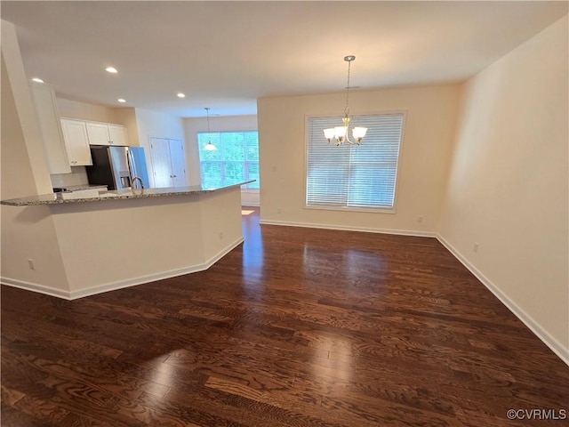 16813 Laurel Park Dr, Moseley, VA 23120 - kitchen with a chandelier, light stone countertops, dark wood-style flooring, white cabinets, and stainless steel fridge with ice dispenser