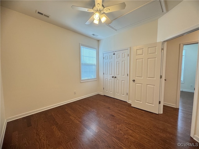 16813 Laurel Park Dr, Moseley, VA 23120 - unfurnished bedroom with attic access, dark wood finished floors, a closet, and a ceiling fan