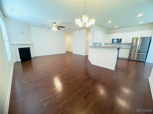 16813 Laurel Park Dr, Moseley, VA 23120 - unfurnished living room featuring a chandelier, dark wood-style flooring, recessed lighting, a ceiling fan, and a fireplace