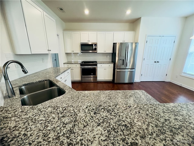 16813 Laurel Park Dr, Moseley, VA 23120 - kitchen featuring stainless steel appliances, light stone countertops, white cabinetry, decorative backsplash, and dark wood-style flooring