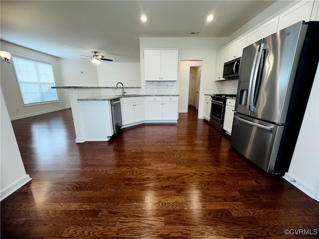 16813 Laurel Park Dr, Moseley, VA 23120 - kitchen with a peninsula, stainless steel appliances, a ceiling fan, decorative backsplash, and light stone countertops