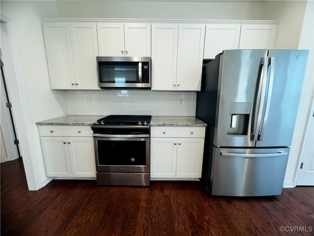16813 Laurel Park Dr, Moseley, VA 23120 - kitchen with appliances with stainless steel finishes, dark wood-type flooring, white cabinetry, backsplash, and light stone counters