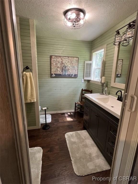 102 Mechams Cove Rd, Topping, VA 23169 - bathroom featuring a textured ceiling, vanity, and wood finished floors