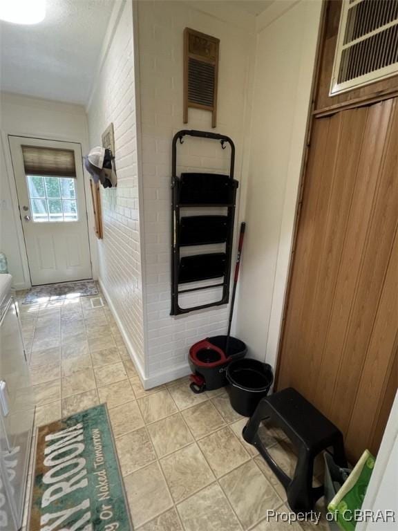 102 Mechams Cove Rd, Topping, VA 23169 - corridor with wood walls and brick wall