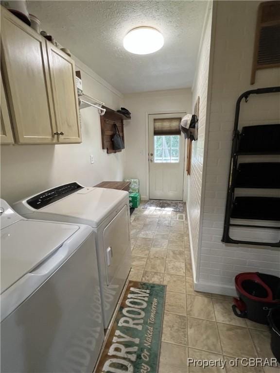 102 Mechams Cove Rd, Topping, VA 23169 - laundry room with cabinet space, washing machine and dryer, and a textured ceiling