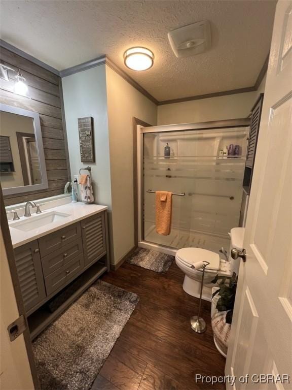 102 Mechams Cove Rd, Topping, VA 23169 - full bathroom with ornamental molding, a shower stall, vanity, wood finished floors, and wooden walls