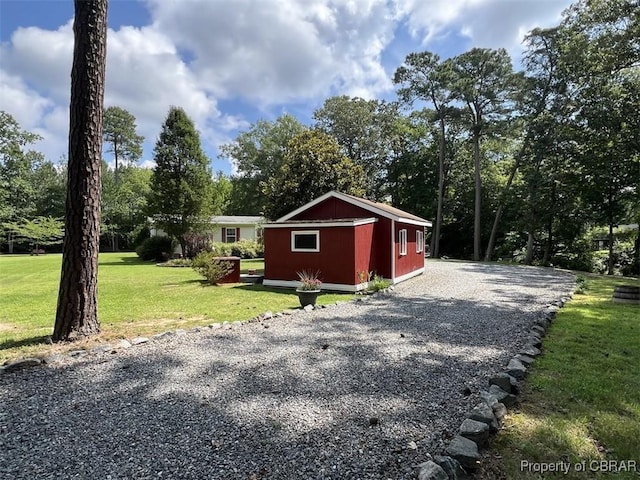 102 Mechams Cove Rd, Topping, VA 23169 - view of outbuilding with gravel driveway and view of scattered trees