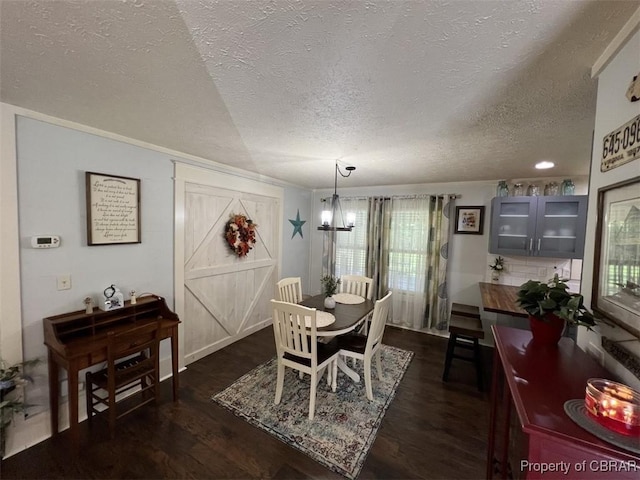 102 Mechams Cove Rd, Topping, VA 23169 - dining space featuring a textured ceiling, dark wood-style flooring, healthy amount of natural light, and a chandelier