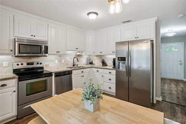 7117 Deer Thicket Dr, Midlothian, VA 23112 - kitchen with appliances with stainless steel finishes, white cabinets, and tasteful backsplash