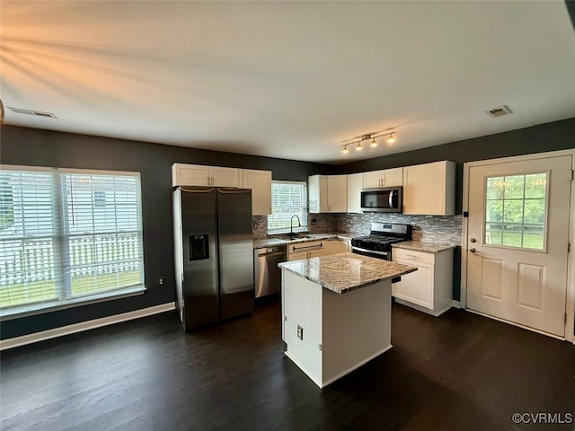 9903 Bethwood Dr, Fredericksburg, VA 22407 - kitchen featuring appliances with stainless steel finishes, tasteful backsplash, plenty of natural light, and white cabinetry