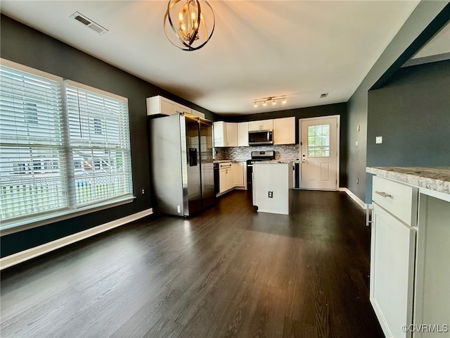 9903 Bethwood Dr, Fredericksburg, VA 22407 - kitchen featuring stainless steel appliances, dark wood-style floors, tasteful backsplash, white cabinetry, and a kitchen island