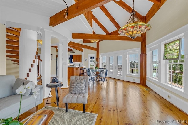 744 Possum Point Rd, Port Haywood, VA 23109 - living area featuring beamed ceiling, stairs, light wood-type flooring, high vaulted ceiling, and ornate columns