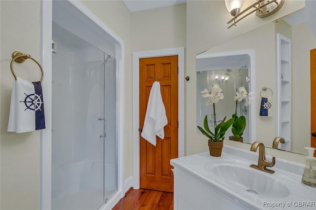 744 Possum Point Rd, Port Haywood, VA 23109 - bathroom with a shower stall, vanity, and wood finished floors