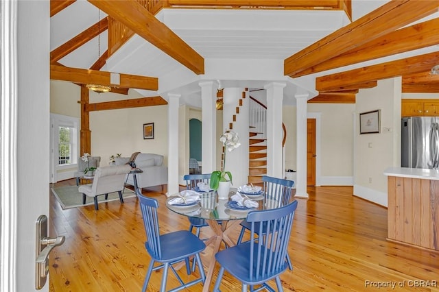 744 Possum Point Rd, Port Haywood, VA 23109 - dining area featuring ornate columns, beamed ceiling, light wood finished floors, and stairway