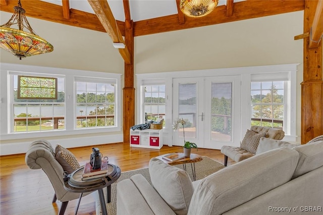 744 Possum Point Rd, Port Haywood, VA 23109 - living room featuring beamed ceiling, healthy amount of natural light, wood finished floors, and high vaulted ceiling