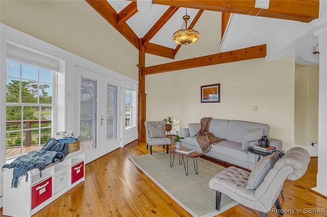 744 Possum Point Rd, Port Haywood, VA 23109 - living room featuring beam ceiling, wood finished floors, and high vaulted ceiling