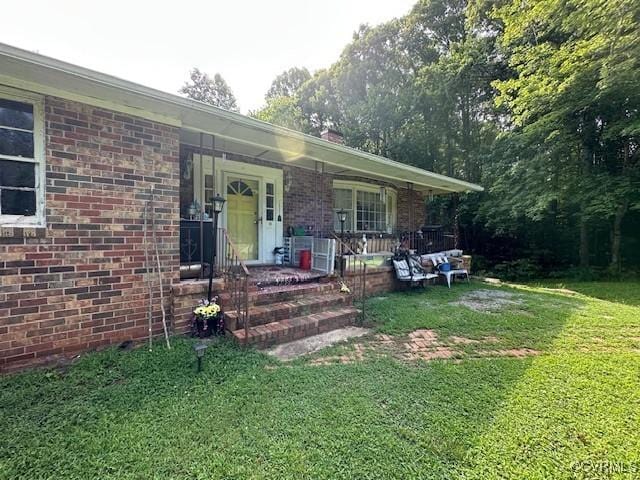 4232 Three Bridge Rd, Powhatan, VA 23139 - property entrance featuring a porch, a lawn, and brick siding