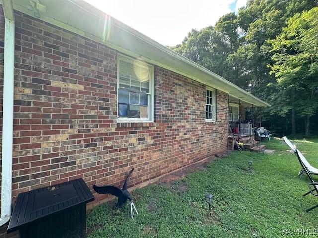 4232 Three Bridge Rd, Powhatan, VA 23139 - view of side of home featuring brick siding and a lawn