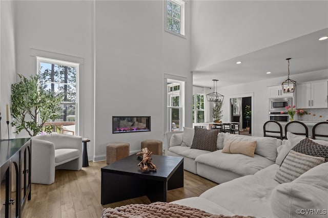 9255 Saxsawn Ln, Chesterfield, VA 23832 - living area featuring healthy amount of natural light, a towering ceiling, light wood-style floors, recessed lighting, and a chandelier