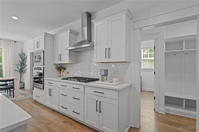9255 Saxsawn Ln, Chesterfield, VA 23832 - kitchen with wall chimney range hood, tasteful backsplash, light countertops, and recessed lighting