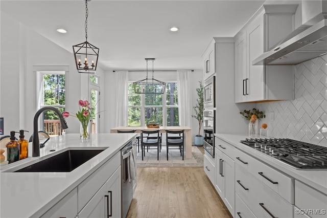 9255 Saxsawn Ln, Chesterfield, VA 23832 - kitchen with wall chimney range hood, light countertops, stainless steel appliances, healthy amount of natural light, and recessed lighting