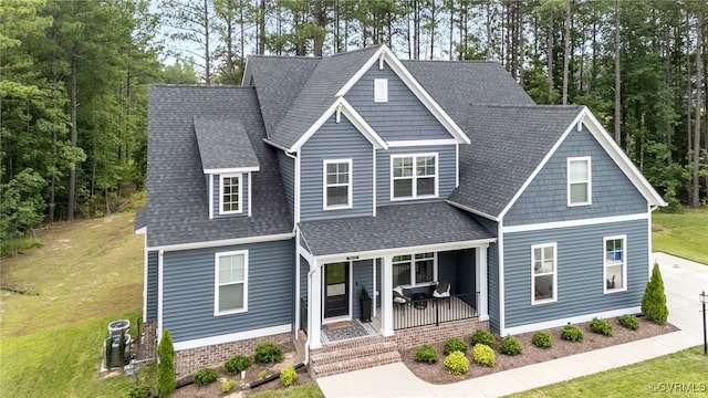 9255 Saxsawn Ln, Chesterfield, VA 23832 - craftsman-style home with covered porch, a shingled roof, and a front lawn