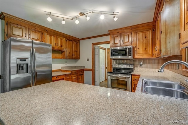 2330 Corner Rock Rd, Midlothian, VA 23113 - kitchen featuring appliances with stainless steel finishes, light countertops, brown cabinets, and a peninsula