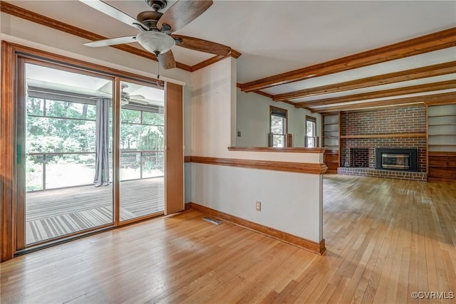 2330 Corner Rock Rd, Midlothian, VA 23113 - unfurnished living room featuring light wood-style flooring, healthy amount of natural light, ceiling fan, a fireplace, and ornamental molding