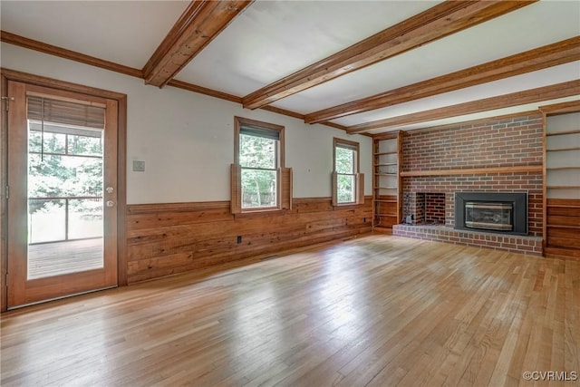 2330 Corner Rock Rd, Midlothian, VA 23113 - unfurnished living room featuring beamed ceiling, a wainscoted wall, light wood finished floors, a brick fireplace, and wood walls