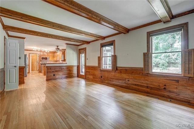 2330 Corner Rock Rd, Midlothian, VA 23113 - unfurnished living room with wainscoting, beamed ceiling, light wood-style floors, wood walls, and a ceiling fan