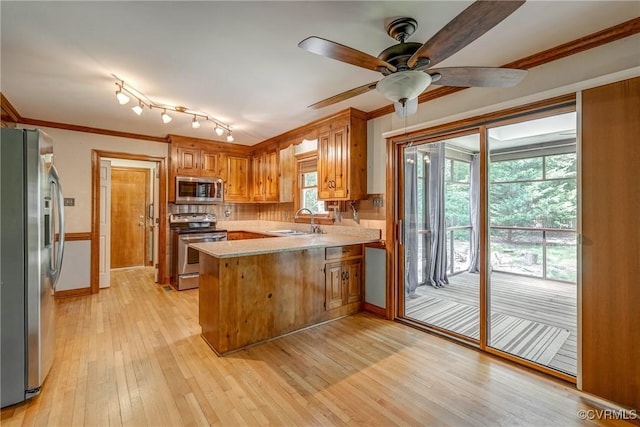 2330 Corner Rock Rd, Midlothian, VA 23113 - kitchen featuring a peninsula, appliances with stainless steel finishes, light countertops, light wood-style floors, and ceiling fan