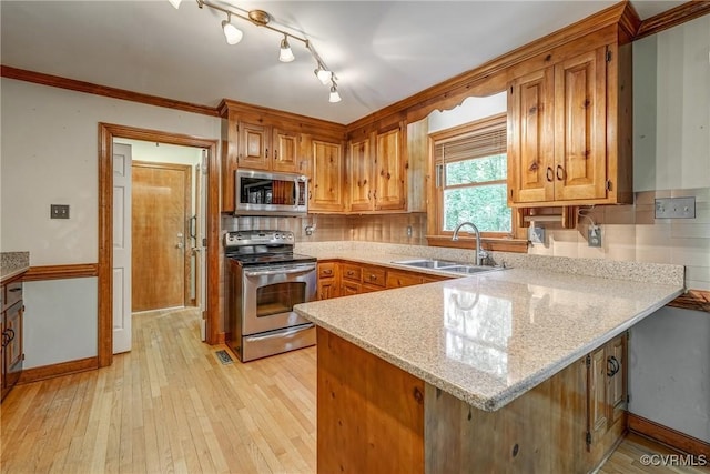 2330 Corner Rock Rd, Midlothian, VA 23113 - kitchen with a peninsula, stainless steel appliances, tasteful backsplash, light wood-type flooring, and crown molding