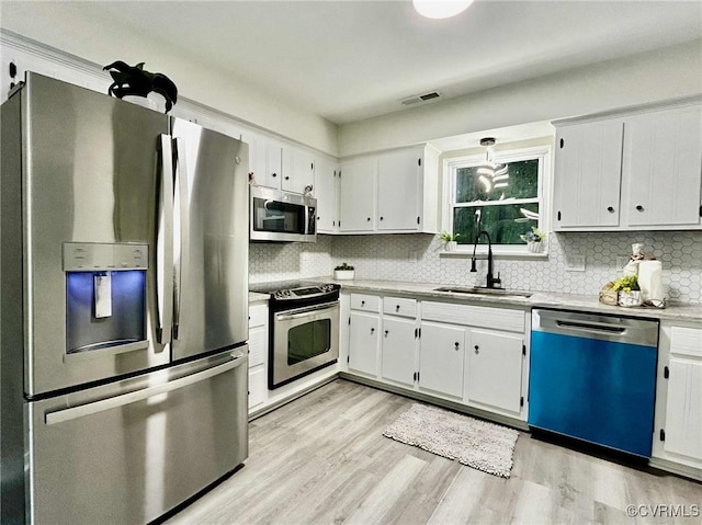 8512 Scottingham Ct, Chesterfield, VA 23236 - kitchen featuring appliances with stainless steel finishes, decorative backsplash, light wood finished floors, and light countertops