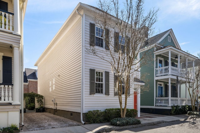 exterior space with a ceiling fan, crawl space, and a balcony