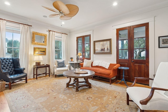 sitting room featuring ornamental molding, light hardwood / wood-style floors, and french doors