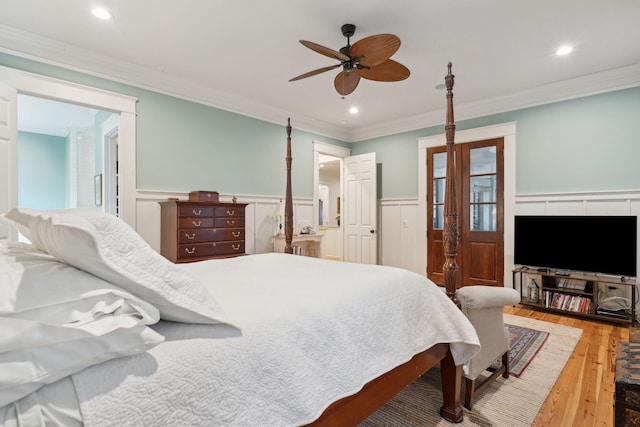 bedroom with hardwood / wood-style flooring, ceiling fan, ornamental molding, and connected bathroom