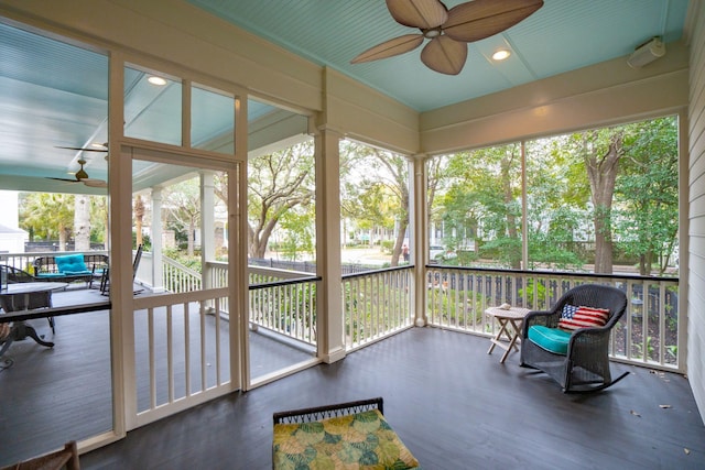 sunroom / solarium featuring ceiling fan