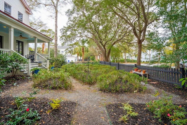 view of yard featuring ceiling fan and a porch