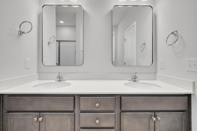 bathroom featuring double vanity and a sink