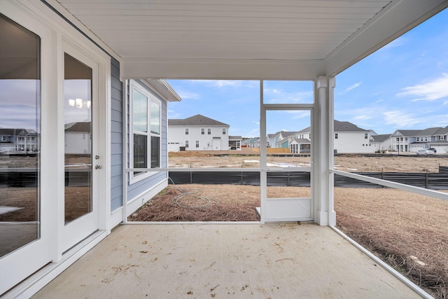 unfurnished sunroom featuring a residential view