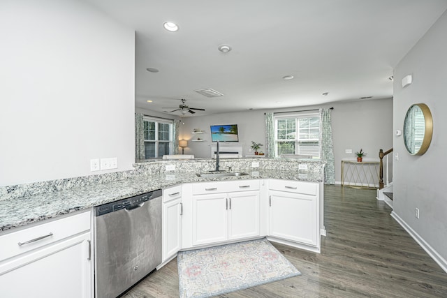 kitchen with sink, dishwasher, kitchen peninsula, white cabinets, and dark hardwood / wood-style floors