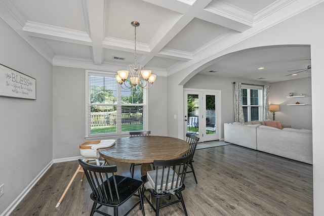 dining space featuring dark hardwood / wood-style floors, beamed ceiling, ceiling fan with notable chandelier, and plenty of natural light