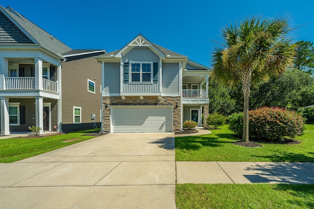 view of front of house with a front lawn, a garage, and a balcony