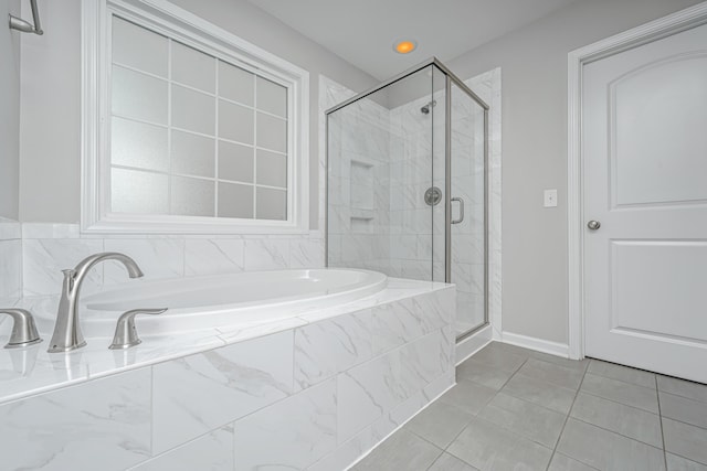 bathroom with shower with separate bathtub and tile patterned floors